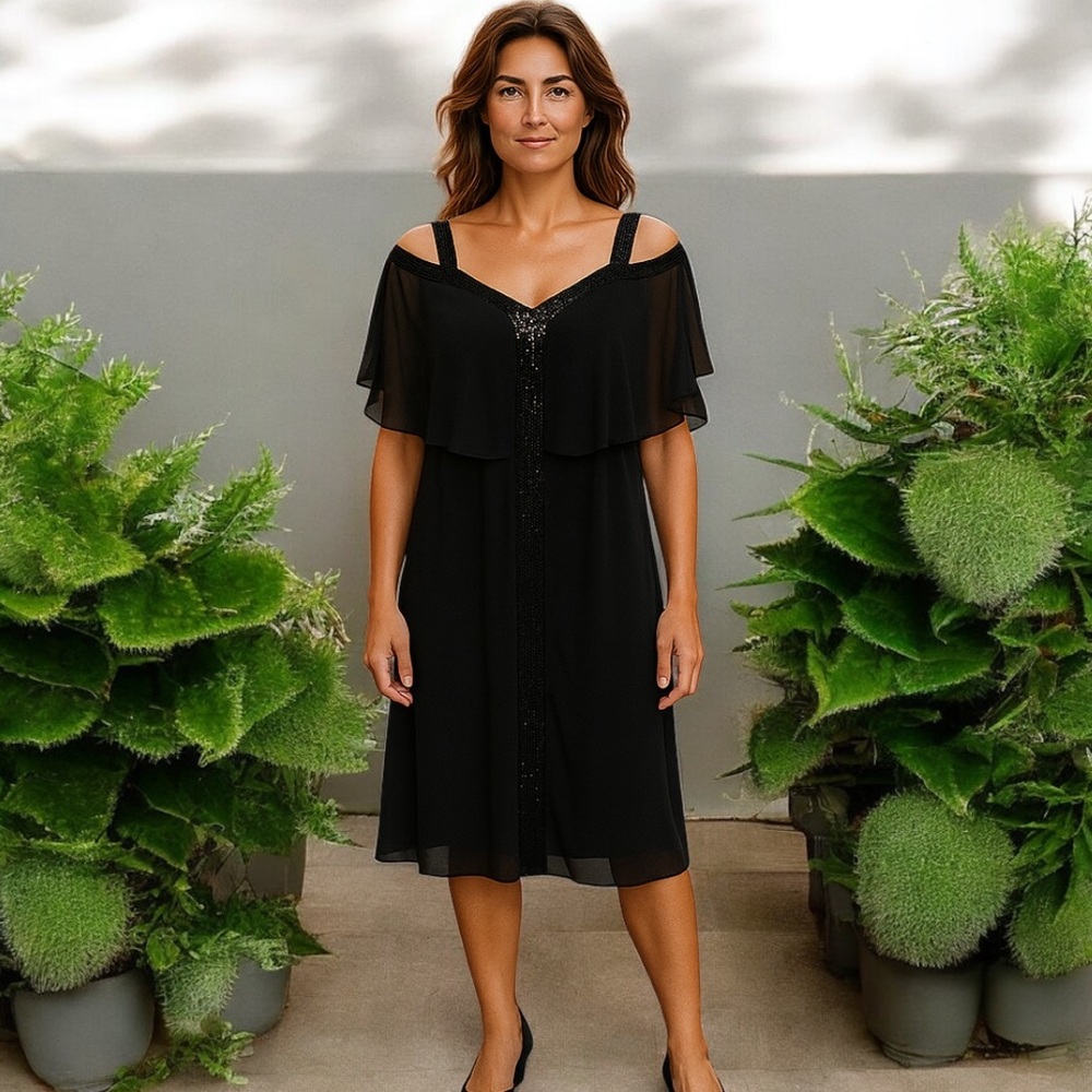 Established 1962 black evening dress with sheer cold shoulder design. Sparkle